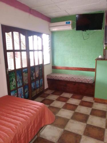 a bedroom with a bed and a tv on the wall at Alodelrafa in San Lorenzo