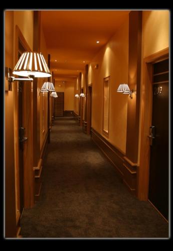 a hallway in a hotel with two lights on the walls at TANA-Boutique Hôtel in Antananarivo