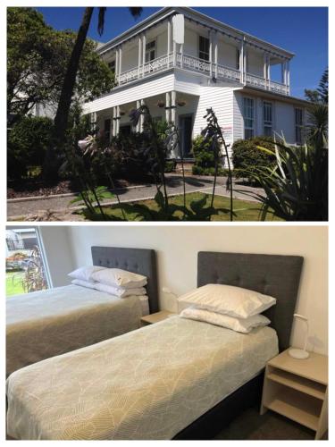 two beds in front of a white house at Tripinn Modern Motels & Affordable Accommodation in Westport