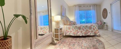 a bedroom with a bed and a mirror at Castaway at Boat Harbour in Boat Harbour