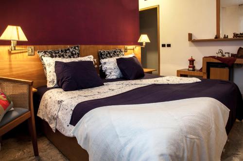 a bedroom with a large bed with two pillows at Albergo Vecchio Forno in Spoleto