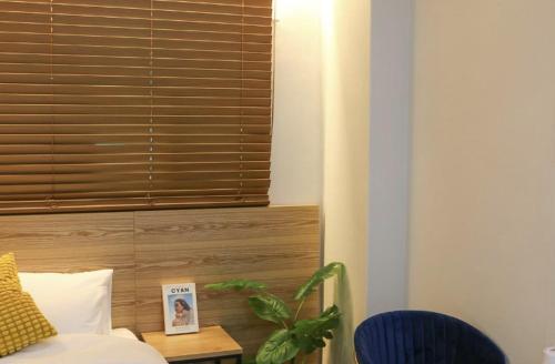 a bedroom with a window and a bed with a table at Stayinn Hotel in Seongnam