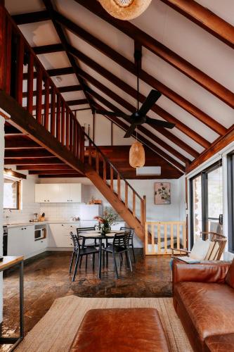 a living room with a table and a kitchen at Cottage 4 - The Row in Forest Grove