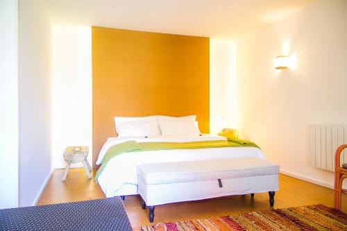 a bedroom with a white bed with a yellow headboard at Liiiving in Porto | Oporto Garden Pool House in Porto