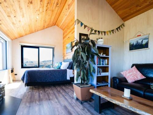 a living room with a bed and a couch at Kūkupa Matairangi at Akaroa Lavender in Akaroa