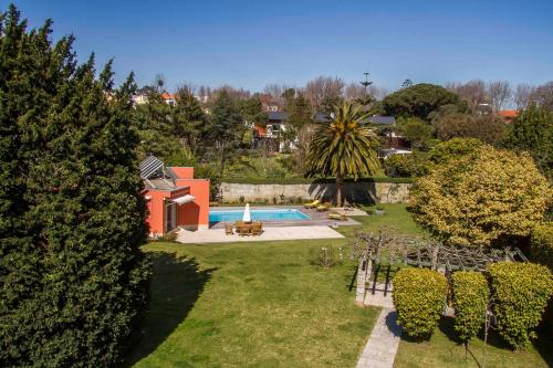 a backyard with a swimming pool and a house at Liiiving in Porto | Oporto Garden Pool House in Porto