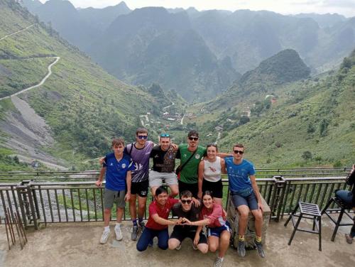 a group of people posing for a picture on a mountain at Ha Giang Eco Bungalow in Ha Giang