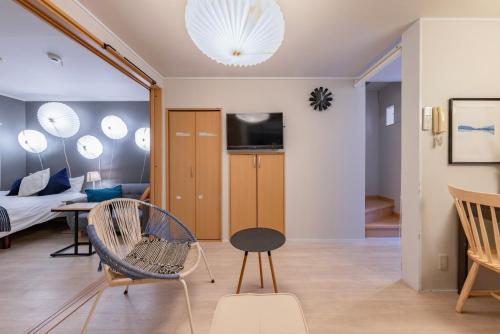 a living room with a chair and a table at Ritz Place Nishikujo in Osaka