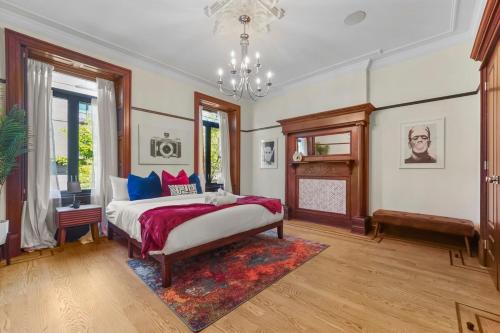 a bedroom with a bed and a chandelier at SWJ544FH Huge 6BR 4BA Backyard Access in New York