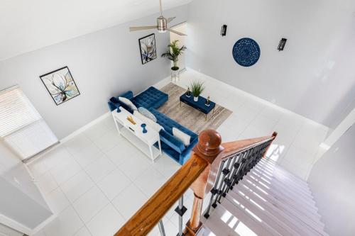 an overhead view of a living room with a blue couch at Heart of Sunrise and Sawgrass in Sunrise