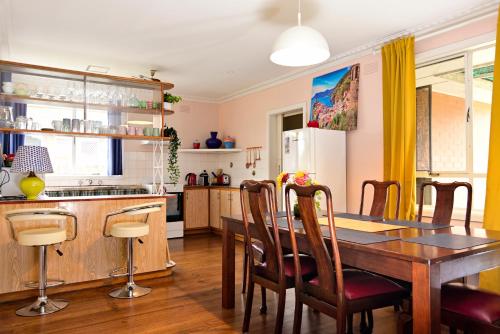 a kitchen with a wooden table and a dining room at Two Pines, whole home in Tullamarine near airport! in Melbourne