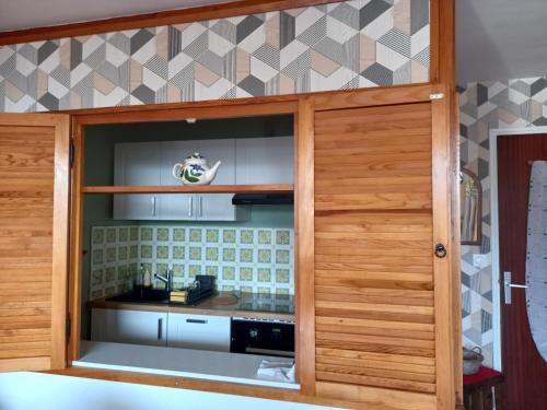 d'une cuisine avec un placard pourvu d'une cuisinière. dans l'établissement Appartement lumineux sud au cœur de Super Besse - FR-1-814-59, à Besse-et-Saint-Anastaise