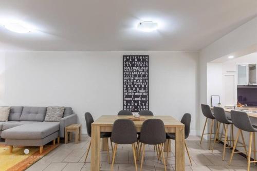 a living room with a table and chairs and a couch at Beaches Retreat - 3 BR w Pool - 5 Min to Beach in Agnes Water