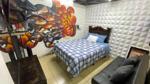 a bedroom with a bed and a painting on the wall at Hotel y Restaurante San Fernando. in Jocotenango
