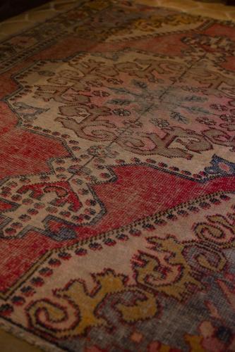 a rug with a cross pattern on a floor at Casa 1810 Parque Hotel Boutique in San Miguel de Allende