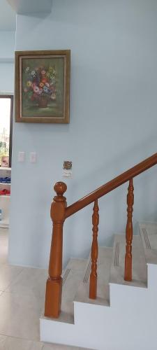 a picture of a painting on a wall next to stairs at Chin-Lan B&B in Zhuangwei