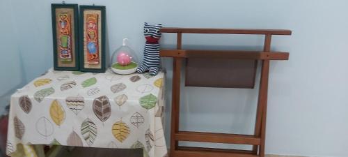 a bed with a table and a book shelf at Chin-Lan B&B in Zhuangwei