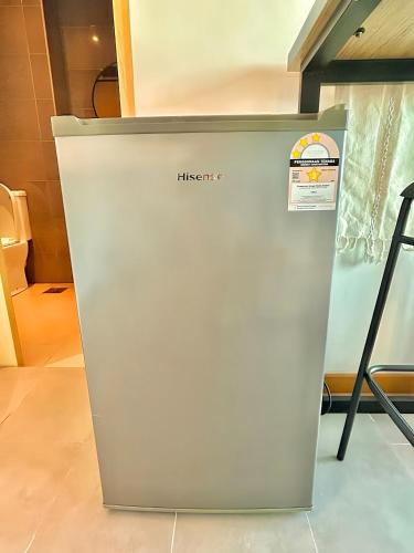 a refrigerator in a room with a sign on it at Imperium Residence Kuantan in Kuantan