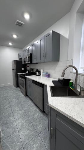 a kitchen with stainless steel appliances and a sink at Beautiful Bedroom with Attached Bathroom, 15 minutes from NYC in West New York