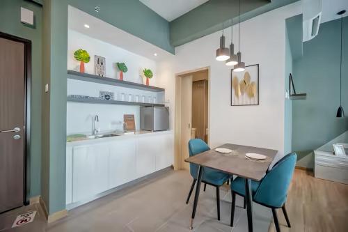a kitchen and dining room with a table and chairs at Imperium Residence Kuantan in Kuantan