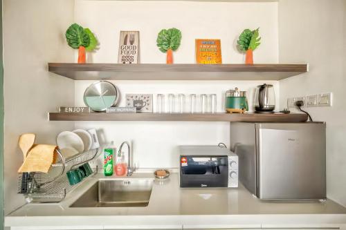 a kitchen with a sink and a microwave at Imperium Residence Kuantan in Kuantan