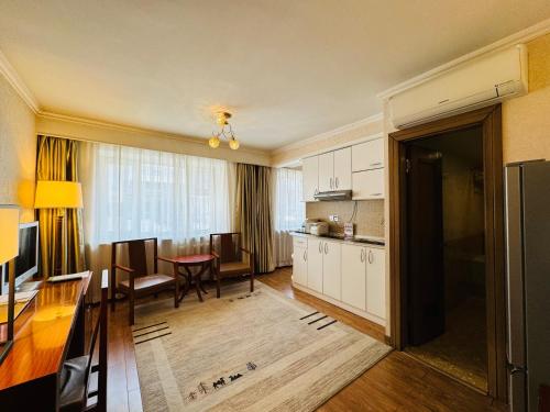 a living room with a kitchen and a dining room at Flower Hotel Ulaanbaatar in Ulaanbaatar