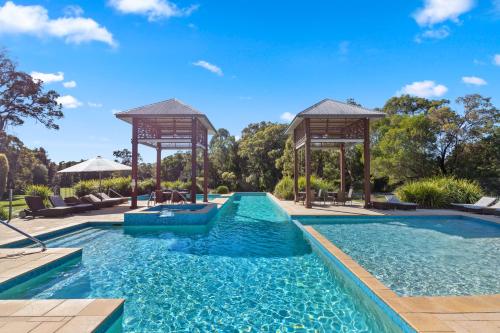a pool with a gazebo and a swimming pool at Senses Noosa North Shore in Noosa North Shore