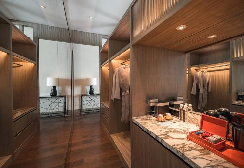 a walk in closet with wooden walls and a dressing room at MGM Shanghai West Bund in Shanghai