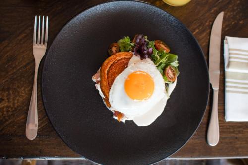 a plate of food with an egg and a salad at Casa 1810 Hotel Boutique in San Miguel de Allende