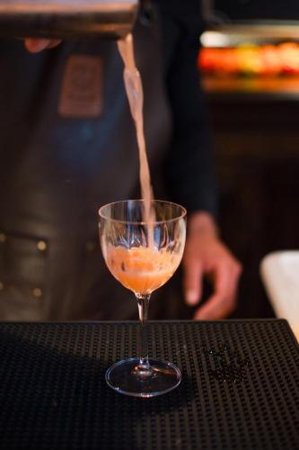 a drink is being poured into a glass on a table at Casa 1810 Hotel Boutique in San Miguel de Allende