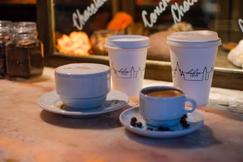 three cups of coffee sitting on a table at Casa 1810 Hotel Boutique in San Miguel de Allende