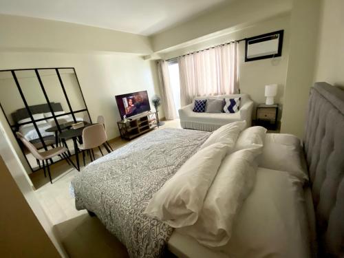 une chambre avec un lit et un salon dans l'établissement Manhattan Plaza Tower 1, Araneta City Cubao, Quezon City, Metro Manila, à Manille