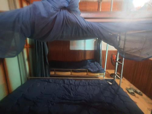 a bed with a canopy in a room at GoHaGiang in Ha Giang