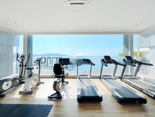a gym with cardio equipment and a large window at Imperium Residence Kuantan in Kuantan