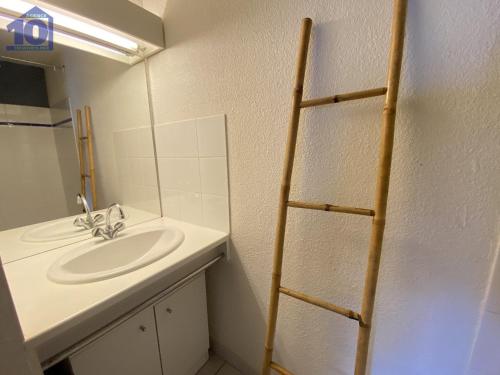 La salle de bains est pourvue d'un lavabo et d'une échelle de serviettes. dans l'établissement Pavillon 4-6 pers, piscine, proche plage, parking sécurisé - FR-1-781-78, à Vendres