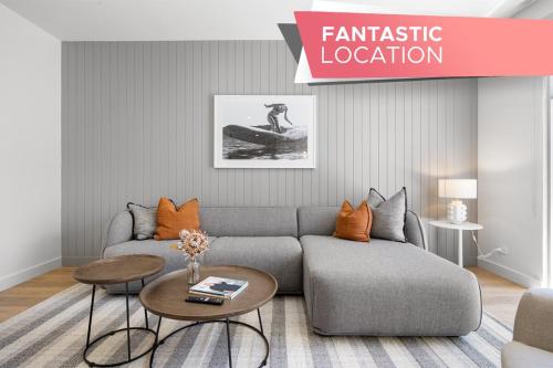 a living room with a couch and a table at Drift at Palmstone - 2BR, Parking, Wifi in Glenelg