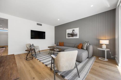 a living room with a gray couch and chairs at Drift at Palmstone - 2BR, Parking, Wifi in Glenelg
