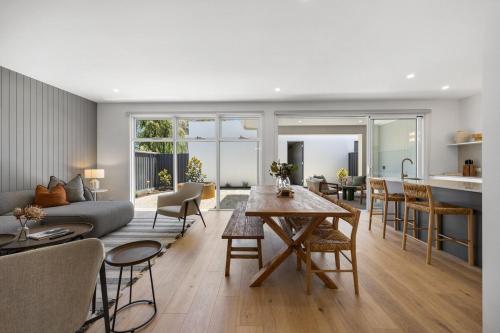 a living room with a couch and a table at Drift at Palmstone - 2BR, Parking, Wifi in Glenelg