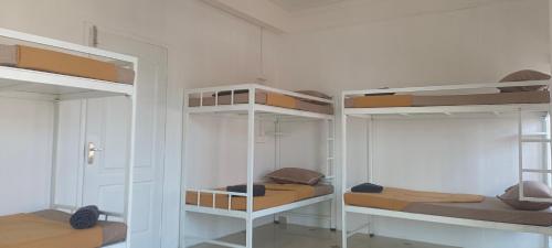 a room with three bunk beds in it at The Cave house in Cochin