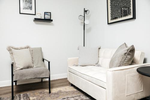 a living room with a white couch and a chair at Breathtaking Oceanview Studio in Redondo Beach