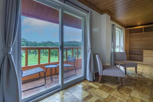 a room with a balcony with a table and chairs at Luxury Residence #3 - Second Floor in Baguio