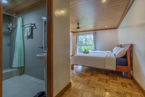 a bedroom with a bed and a shower and a bathroom at Luxury Residence #3 - Second Floor in Baguio