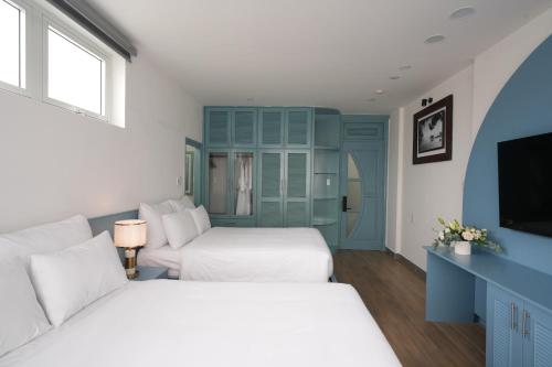a hotel room with two beds and a tv at Dream Light Villa in Khu Chi Lăng