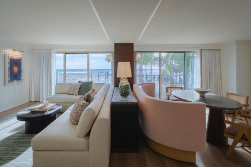 a living room with a couch and a table at Regent Santa Monica Beach in Los Angeles