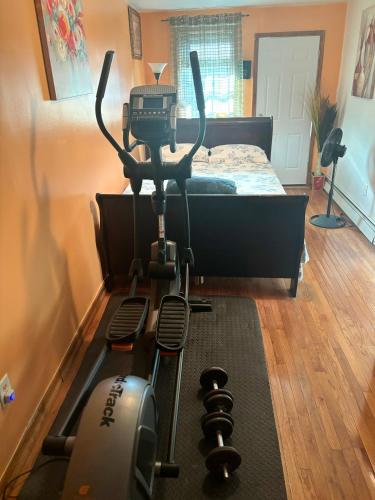 a room with a camera on a treadmill next to a bed at STOPnREST EATnSLEEP FOR BUSY BODY ON THE MOVE in Queens