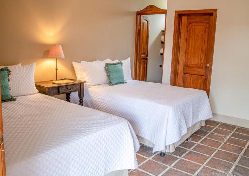 Postel nebo postele na pokoji v ubytování Hotel Casa Carmina by AHS