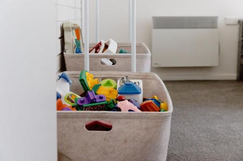 an open suitcase full of toys in a room at Rockpool Cape Paterson in Cape Paterson