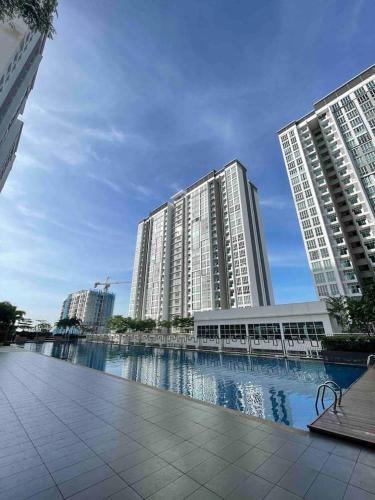 two tall buildings with water in front of them at Near MMHE - 3 Bedrooms Homestay Meridin Bayvue Pasir Gudang in Masai