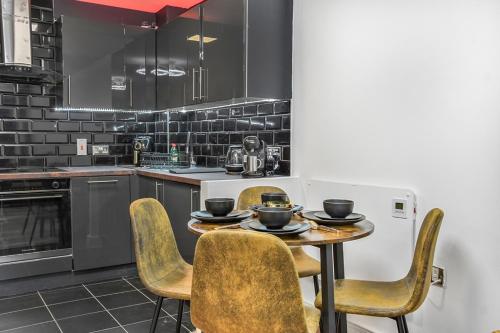 a kitchen with a table and chairs in a kitchen at ABBAccommodation in London
