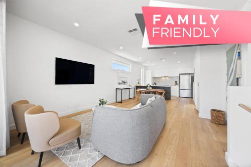 a living room with a couch and chairs and a tv at Cove at Palmstone - 2BR, Parking, Wifi in Glenelg